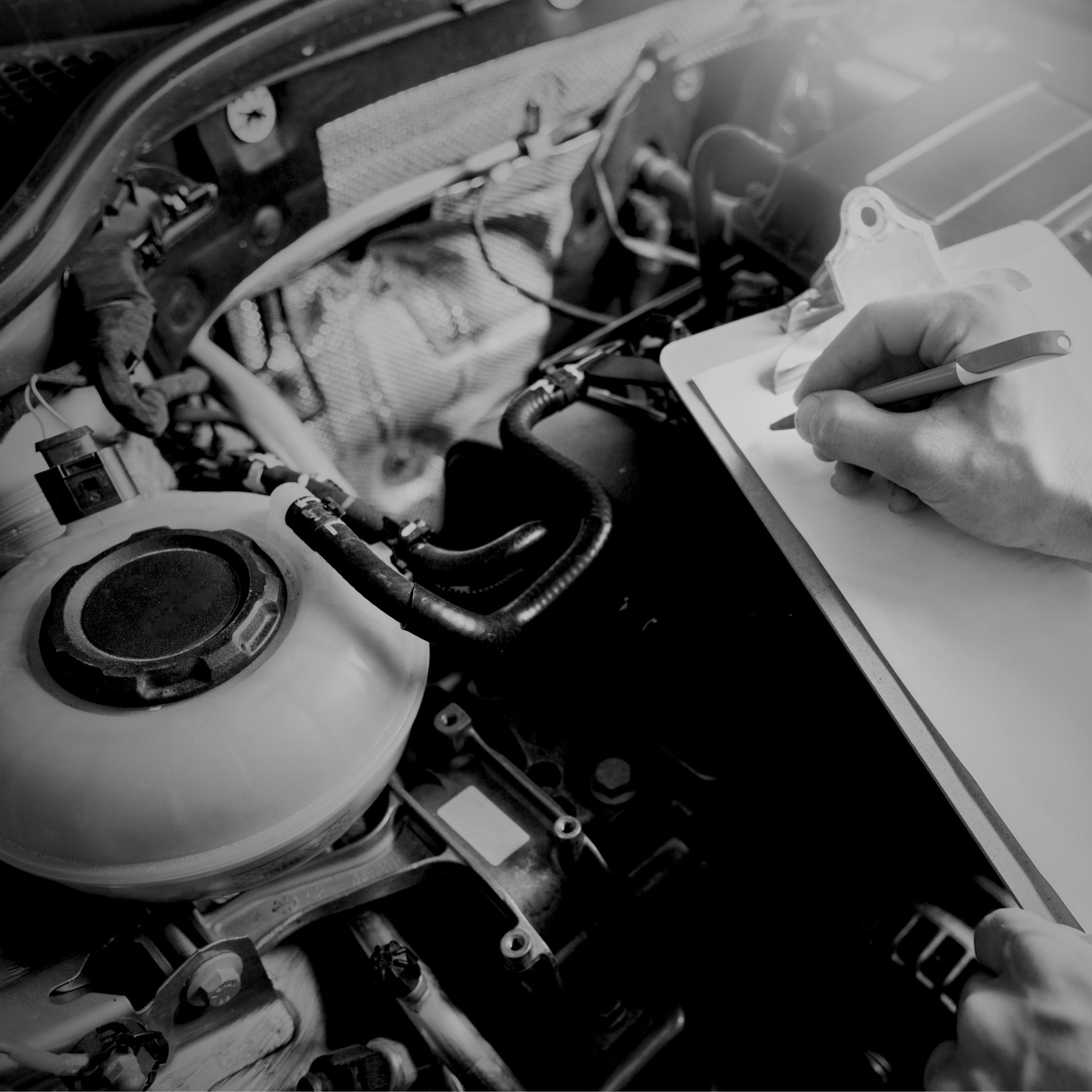 Mechanic conducting car MOT in garage